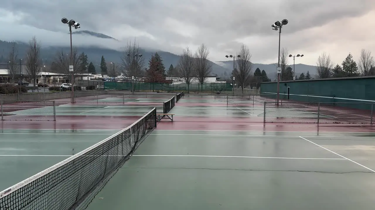 Rain clouds pass over a wet tennis court in Oregon