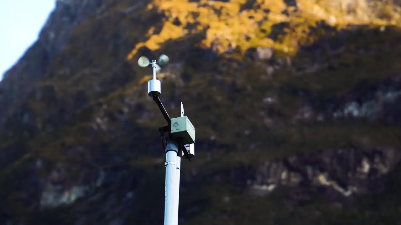 Automatic weather station with weather monitoring system against majestic mountain range of New Zealand