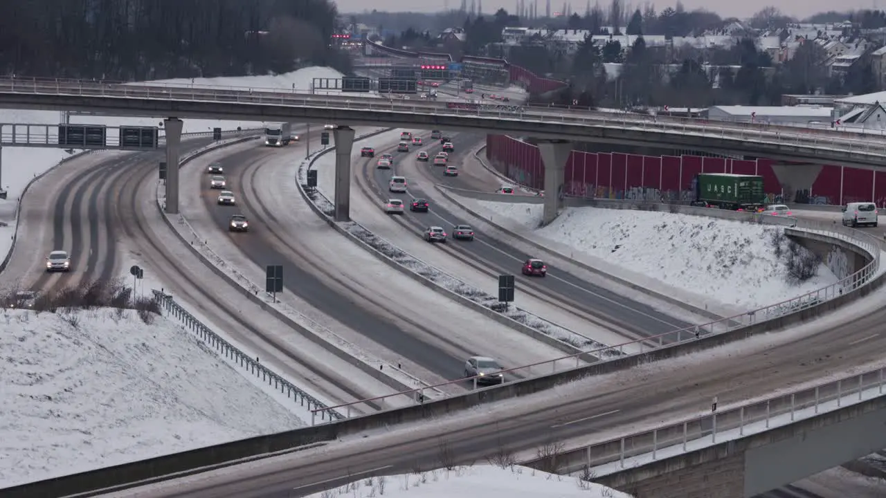 Traffic moving slowly along snowy Highway interchange in Germany