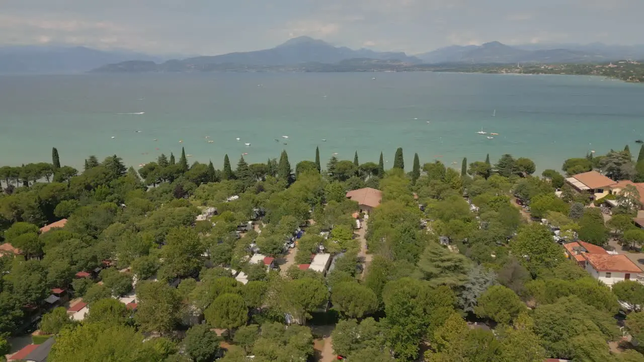 Drone flying over beautiful countryside in Italy with Lake Garda