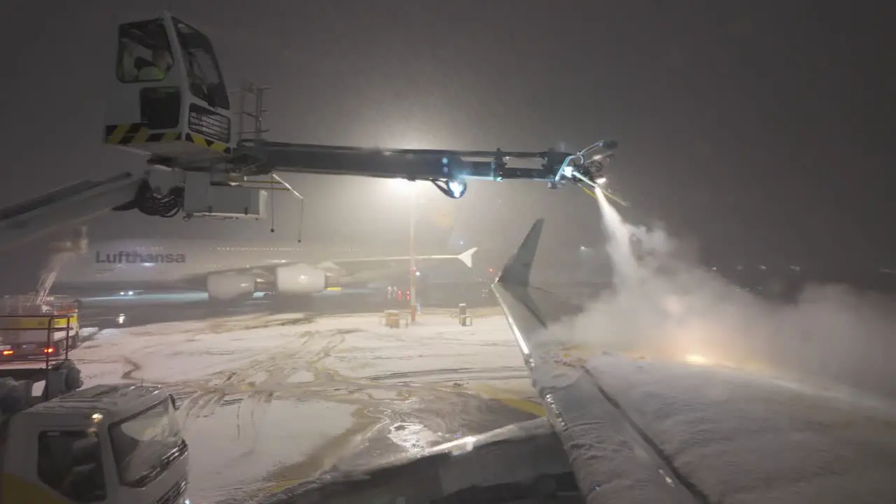 Aircraft Wing De-icing On A Winter Night In Munich Airport Germany