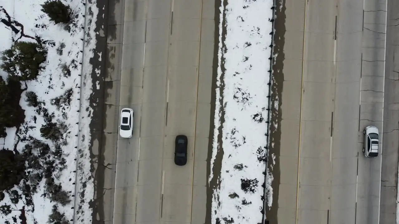 Cars Pass on snowy freeway