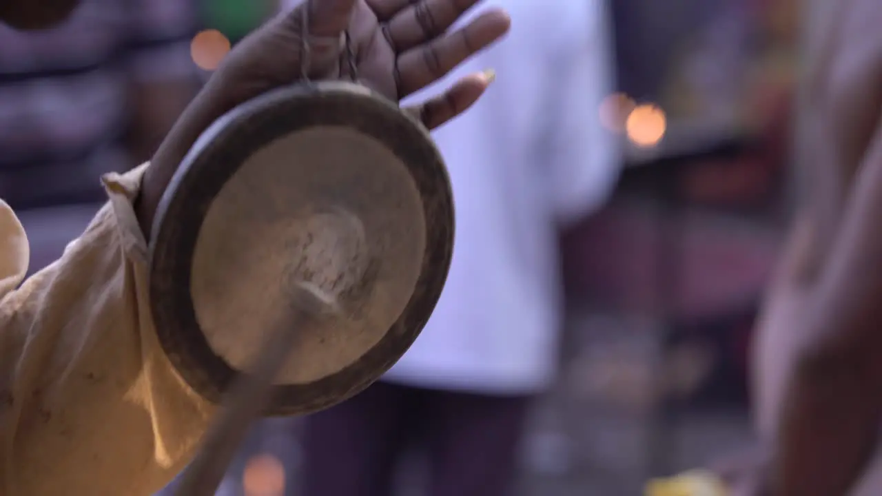 A man plays the kasar in the fair