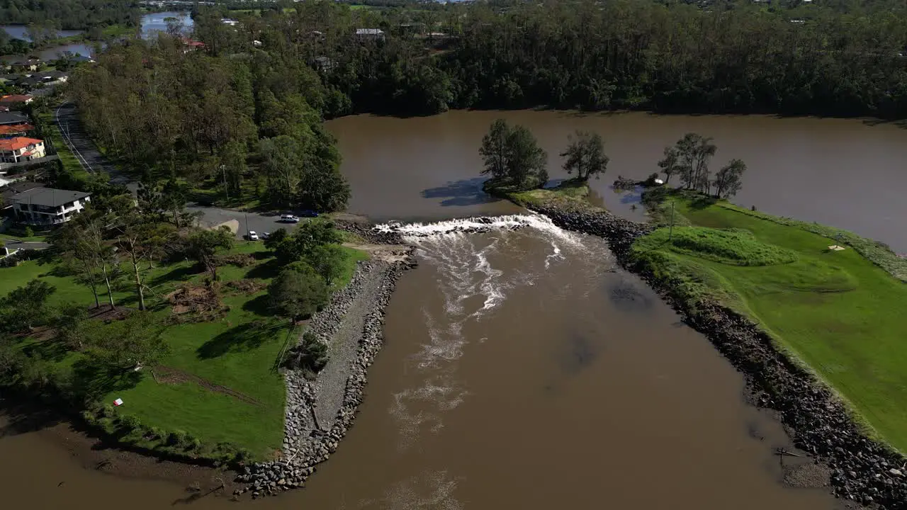 Oxenford Gold Coast 4 January 2024 Rising aerial shot of the Coomera River and Causeway with receding flood waters from the January storms