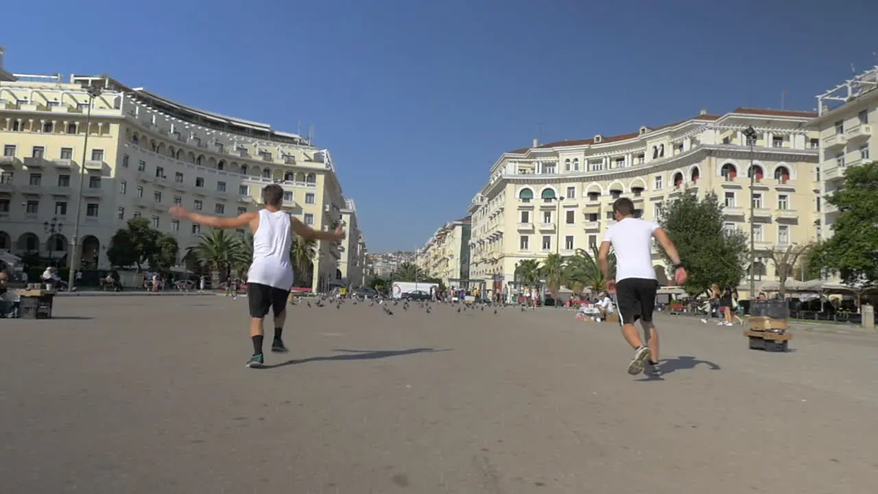 Two guys doing acrobatic tricks outdoors