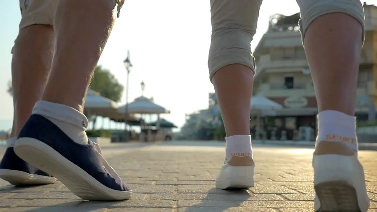 Two people running on the pavement