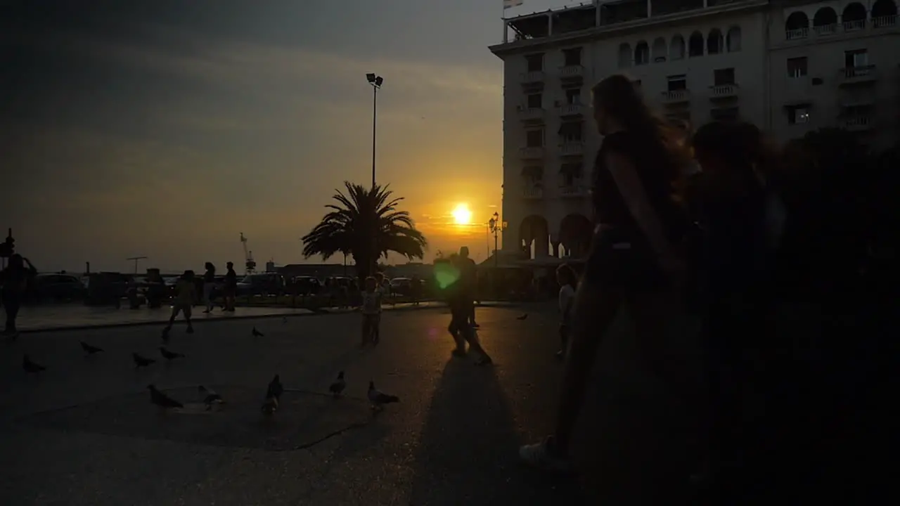 People walking and playing on the square on sunset