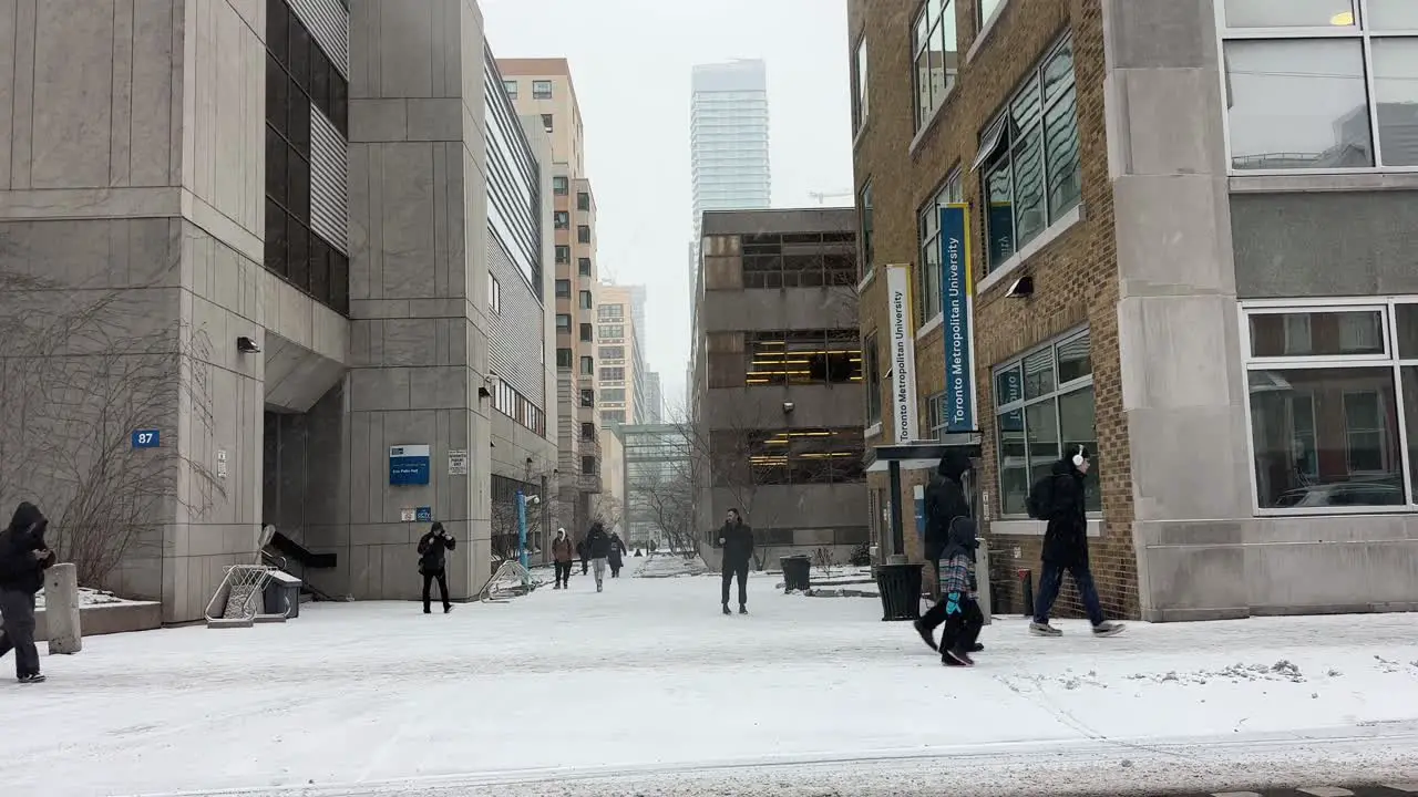 TMU Toronto Metropolitan University during winter snow storm and people walking