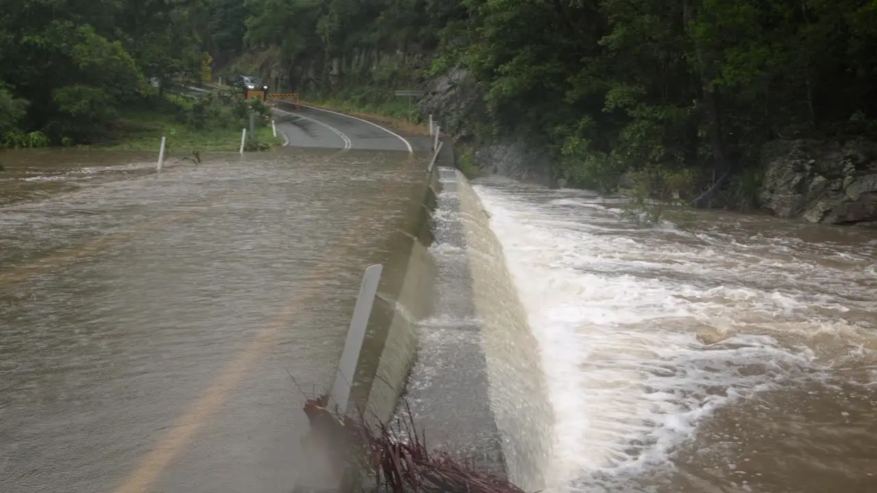 Mudgeeraba Gold Coast 02 January 2024 Close shot of flooding across Mudgeeraba Creek Bridge causing road closure