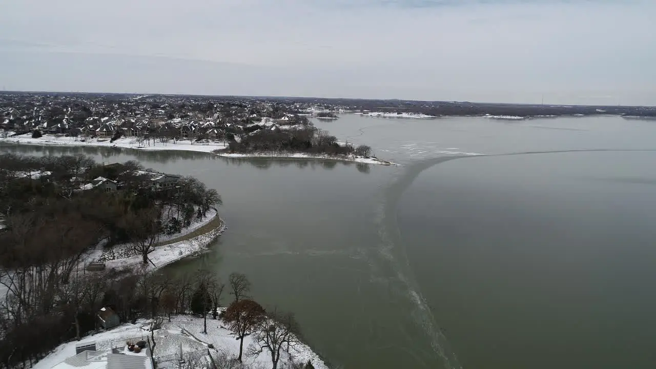 Aerial video of Lake Lewisville in Texas frozen on 2-16-2021