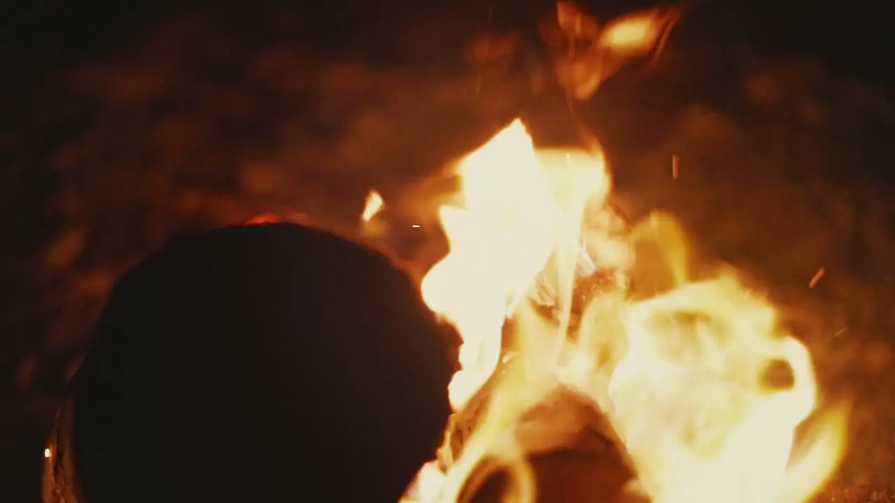 Closeup shot of flames rising up from blazing bonfire in desert slow motion