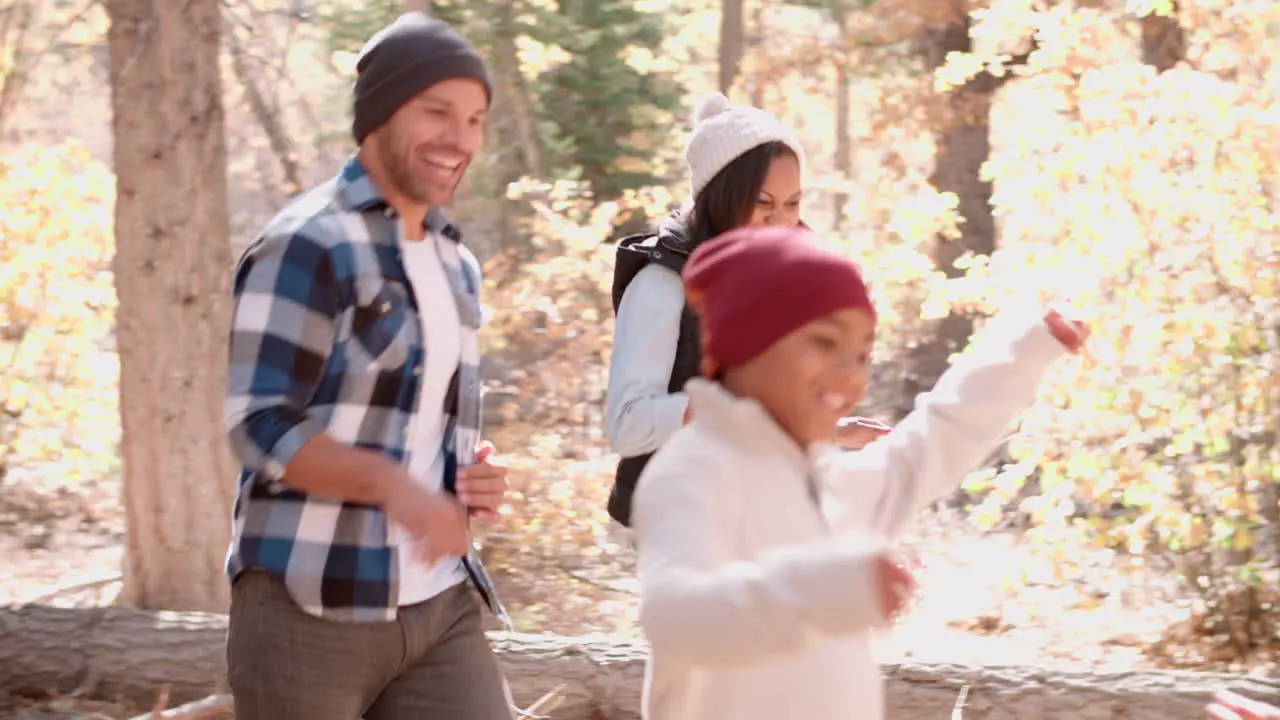 Energetic family running in forest side view close up