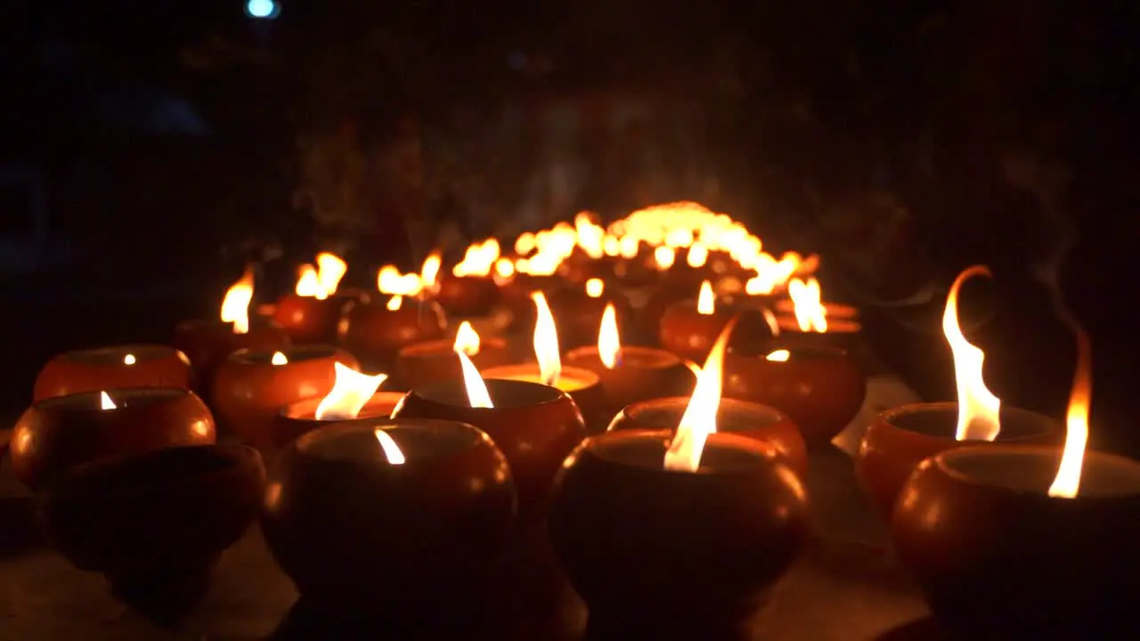 Slow motion view of burning candles at night