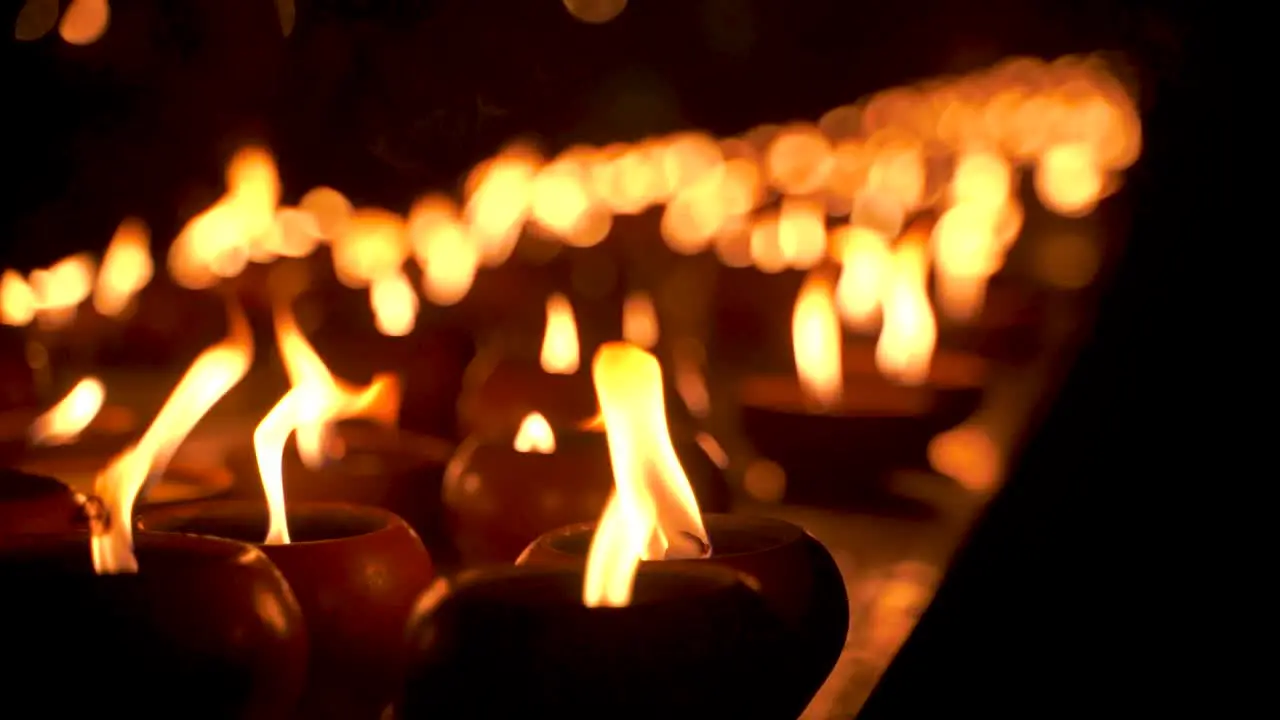 Mysterious view of candles at night burning in slow motion close up