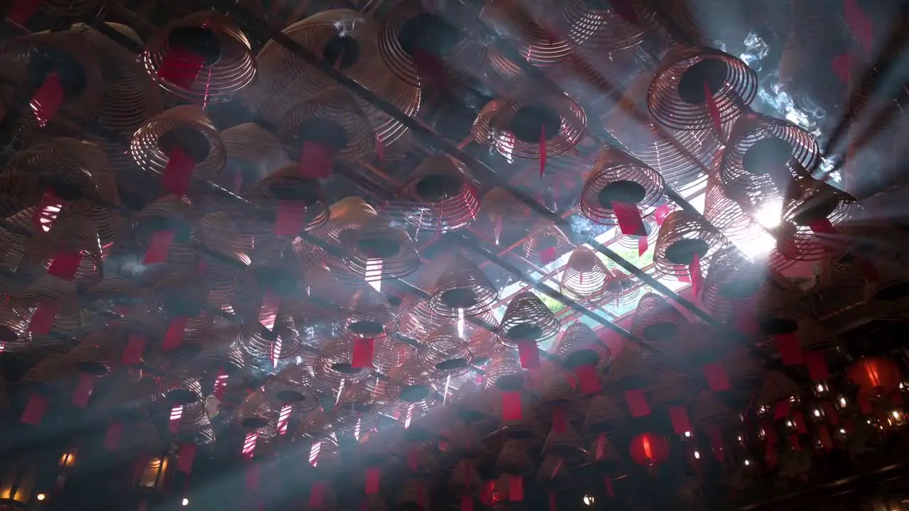 Incense coils hanging from the ceiling as they burn inside a Taoist temple to attract the attention of the gods in Hong Kong