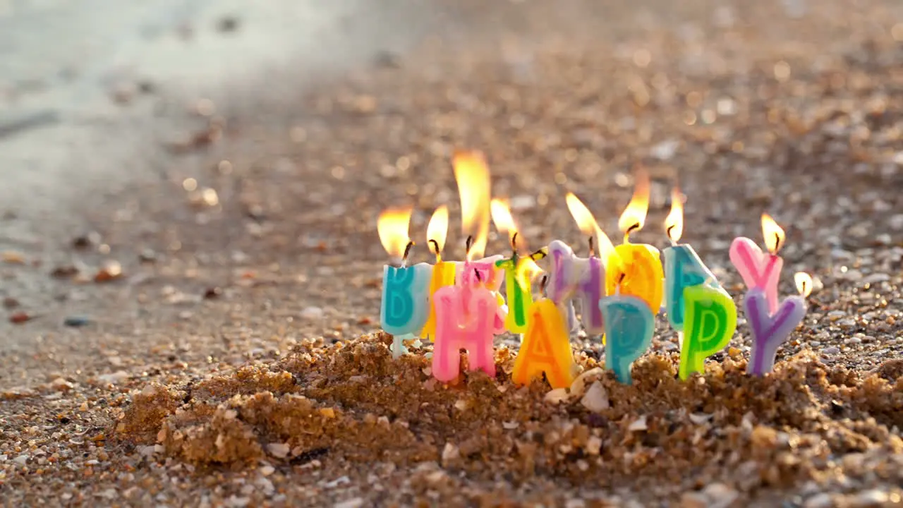 Birthday candles burning on a seashore