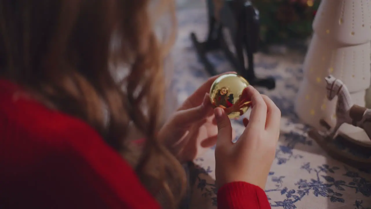 Woman with bauble at table during Christmas