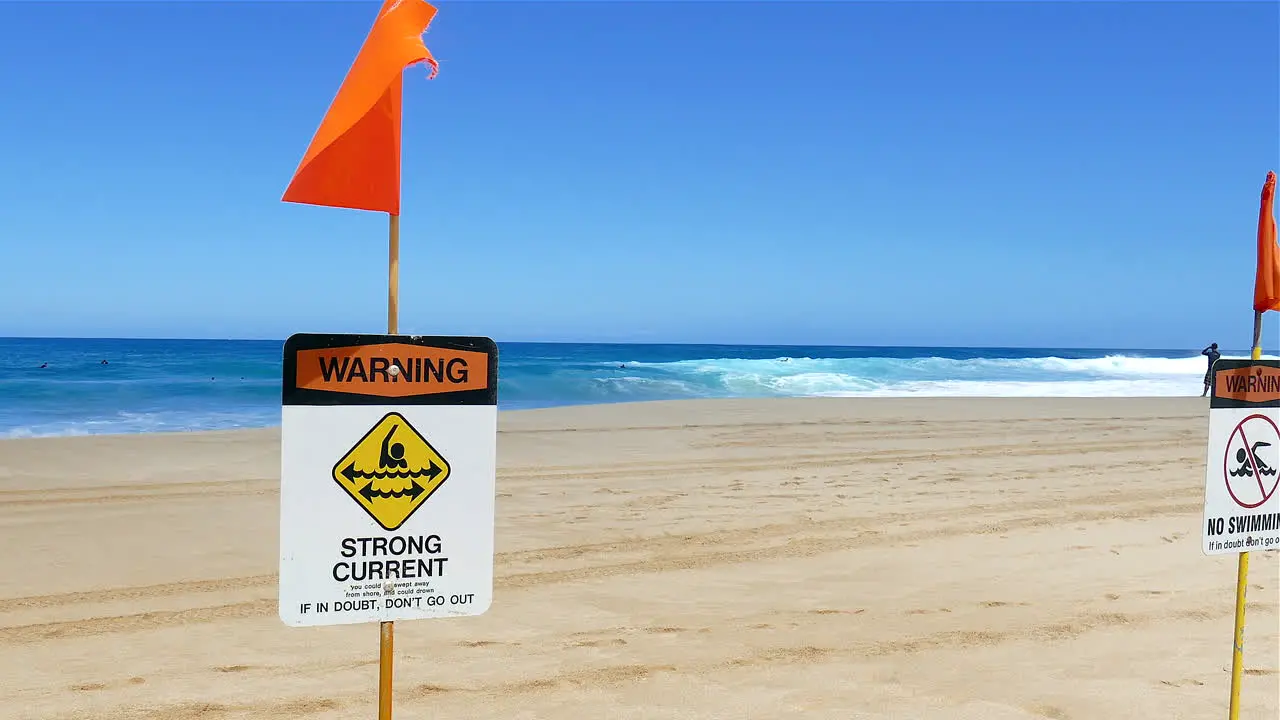 footage of strong current and no swimming signs on the North shore of Oahu Hawaii