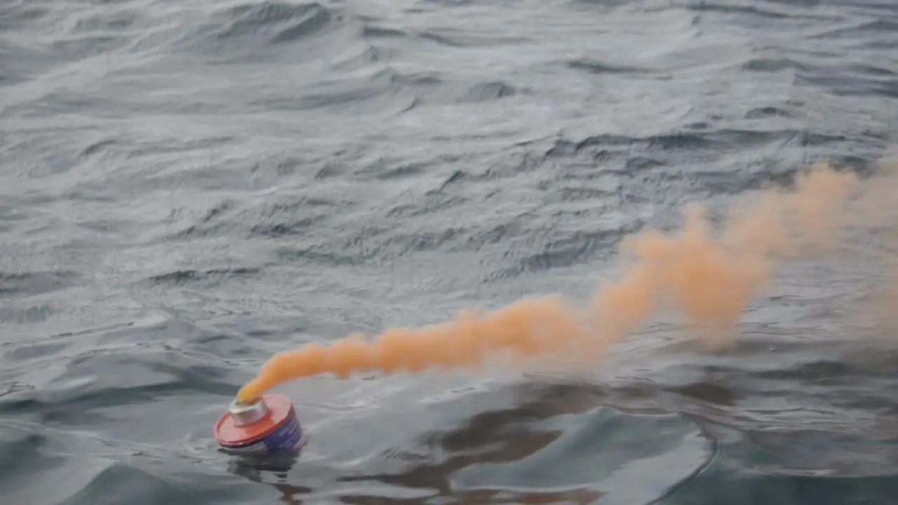 An Orange Smoke Flare Used In Distress Signal Testing Floating In Patagonian Sea During The Nautical Training Closeup Shot