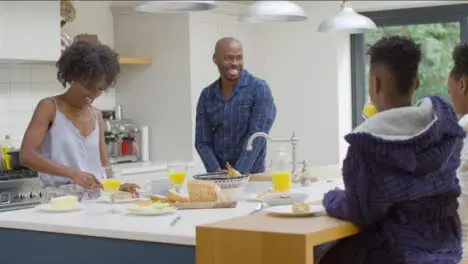 Family Enjoying Breakfast Together at a Kitchen Island 