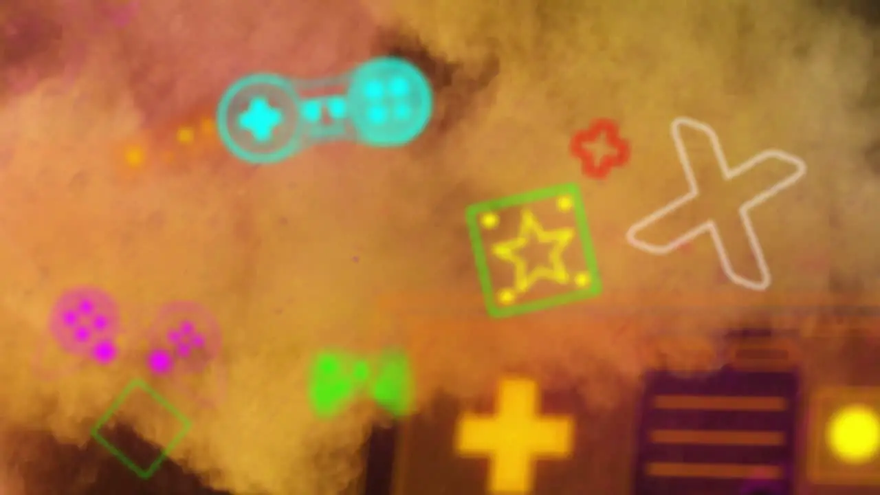 Animation of colourful video game controllers and icons over yellow and orange powder particles