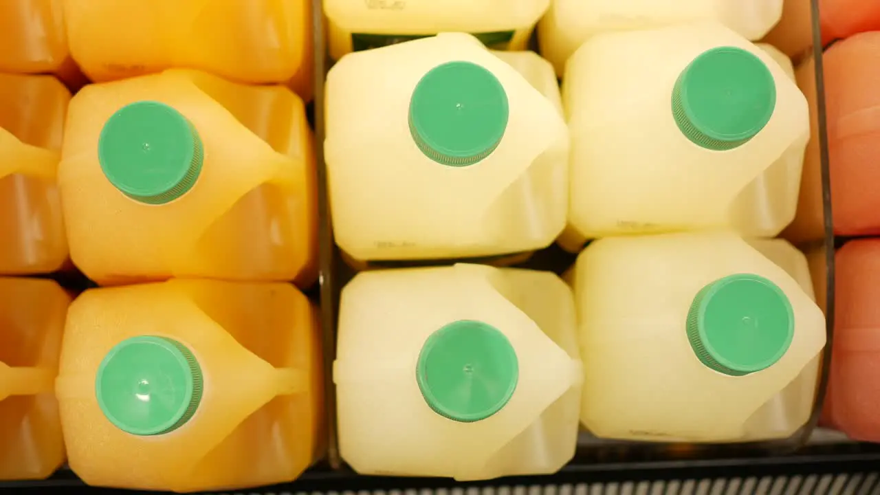 Plastic bottle of orange juice in a shelf 