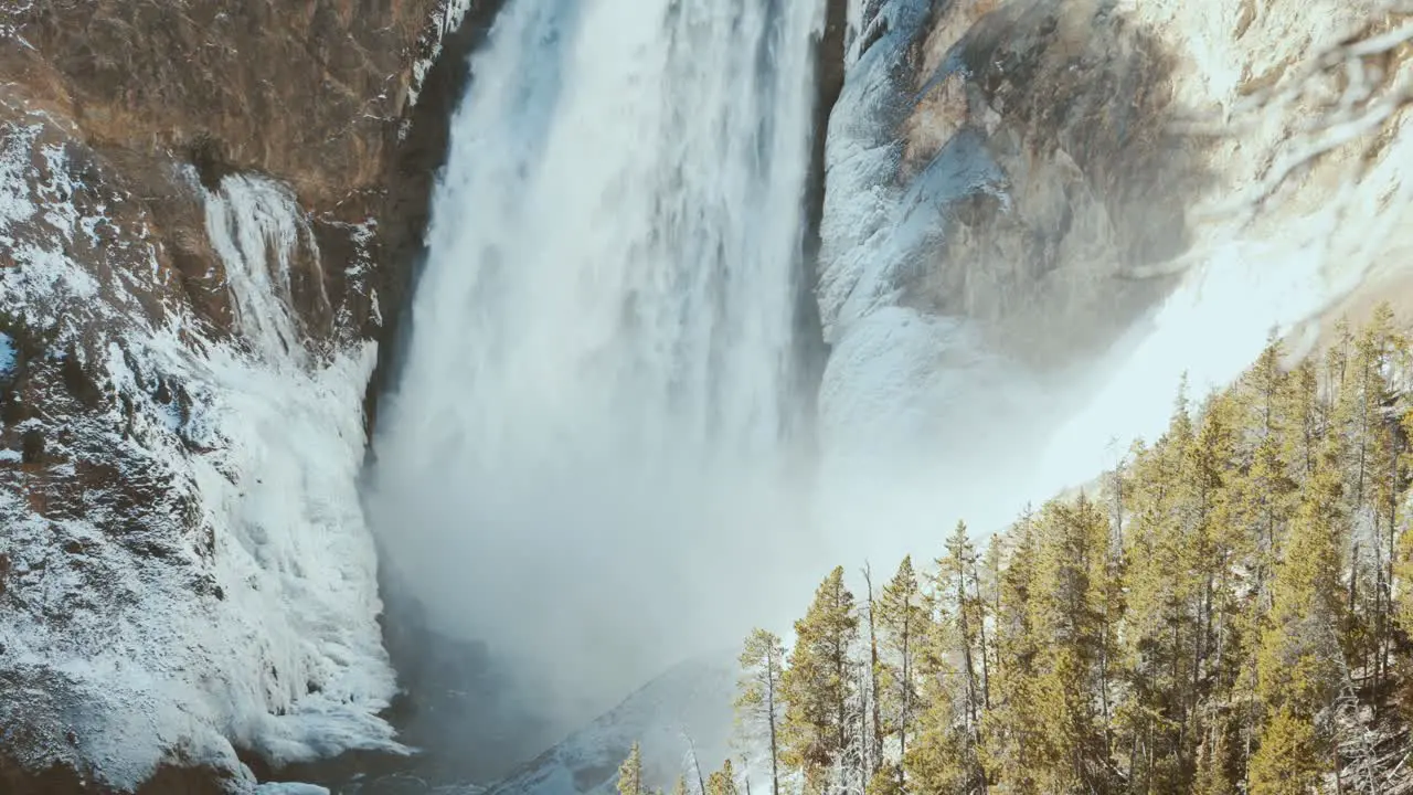 Yellowstone falls with ice and snow narrow shot