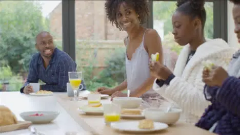 Family Enjoying Having Breakfast Together at a Kitchen Island