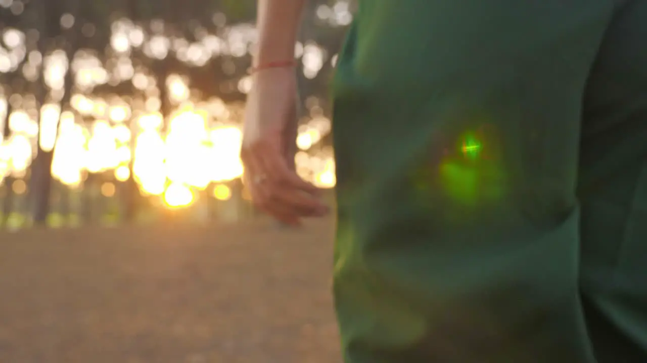 Beautiful Woman Walking Alone In The Forest Towards The Orange Afternoon Sun Close-up Shot