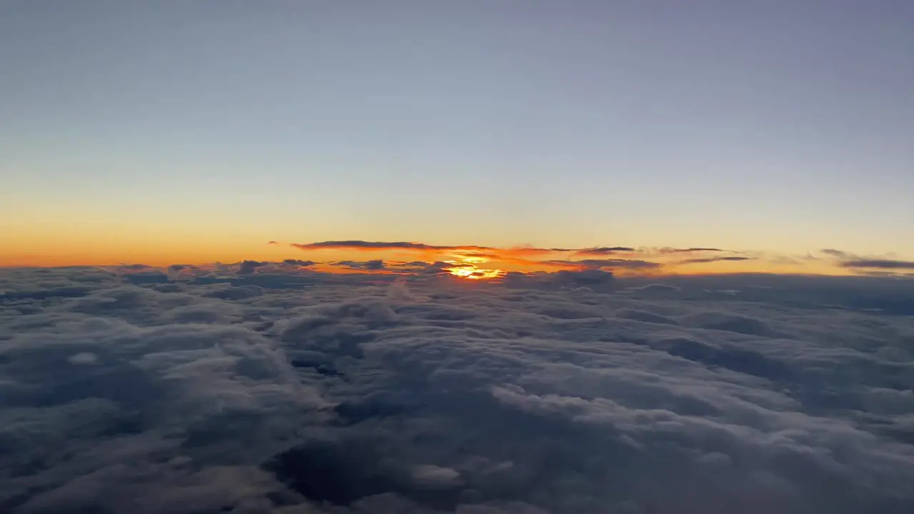 Sunset cloudy sky with a red sun