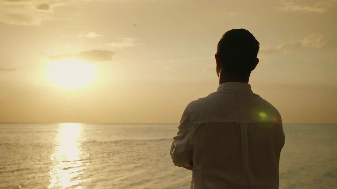 Lonely Man Looking Forward To The Sunset Over The Sea Back View Romance And Vacation At Sea