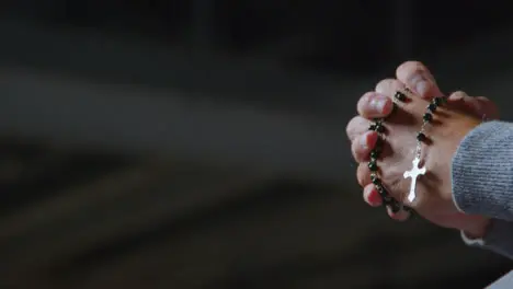 Low Angle Shot of a Senior Mans Hands Holding Some Rosary Beads