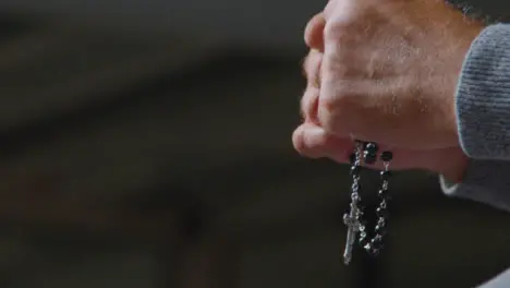 Low Angle Shot of a Senior Mans Hands Holding Rosary Beads