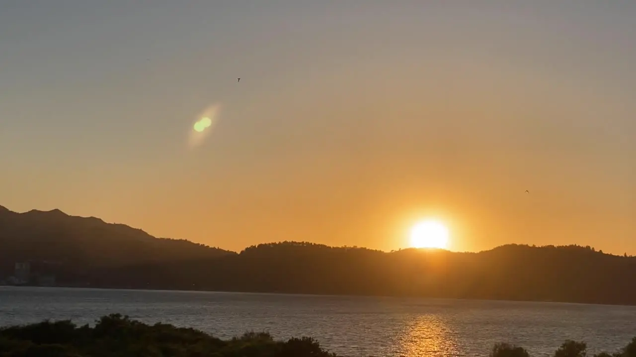 An excellent aerial shot of the sun setting over the Sesimbra Mountains in Portugal