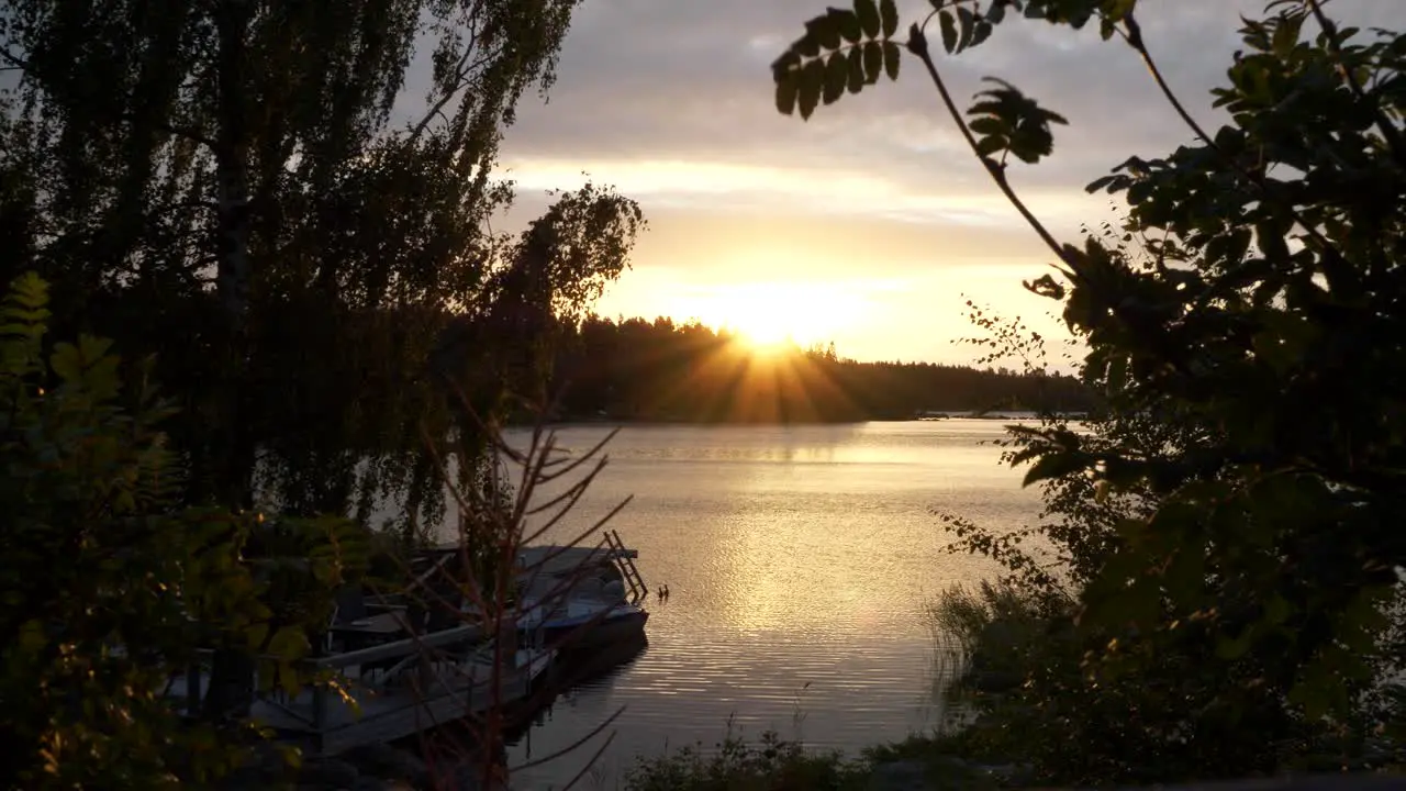 Sunset over lake in Finland Beautiful Summer night scene Boat resting at dock