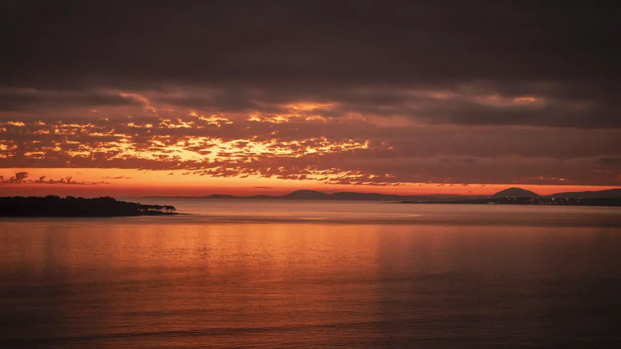 Day to night time lapse of Punta del Este beach at sunset with rippled ocean surface and Gorriti island in background Uruguay