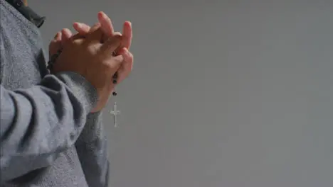 Close Up Shot of Senior Mans Hands Holding Rosary Beads with Copy Space