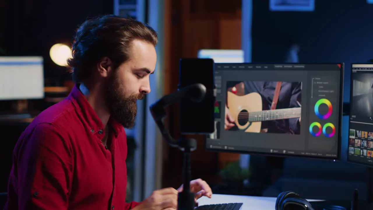 Videographer filming online tutorial with phone about utilizing editing software to assemble footage