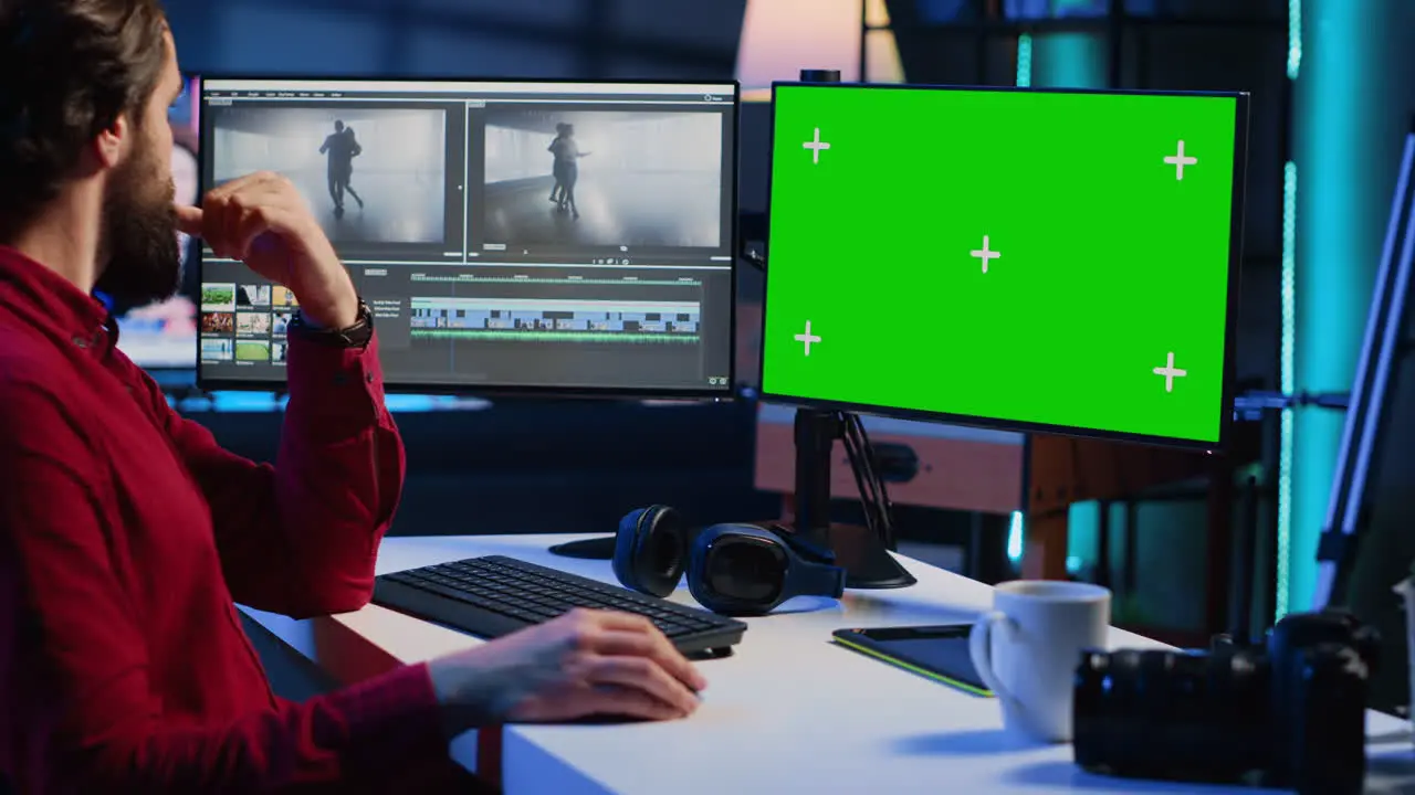 Videographer splicing film pieces editing them using professional software on mockup computer