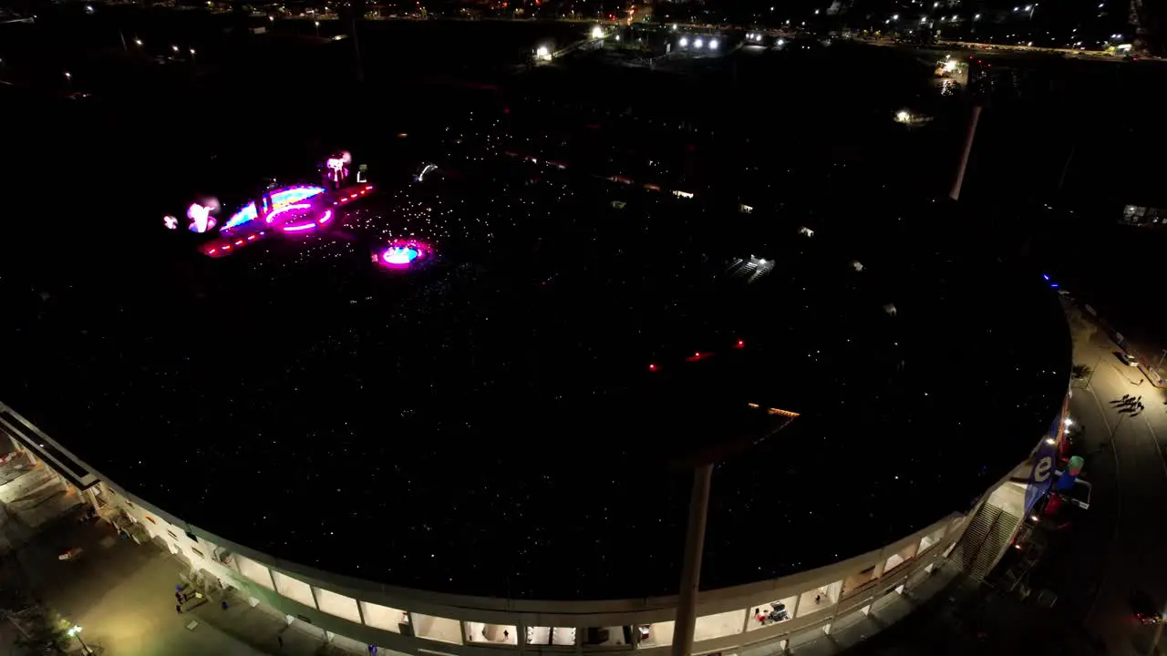 Aerial orbiting national stadium of Chile during World tour of Coldplay Crowded Stadium with light show