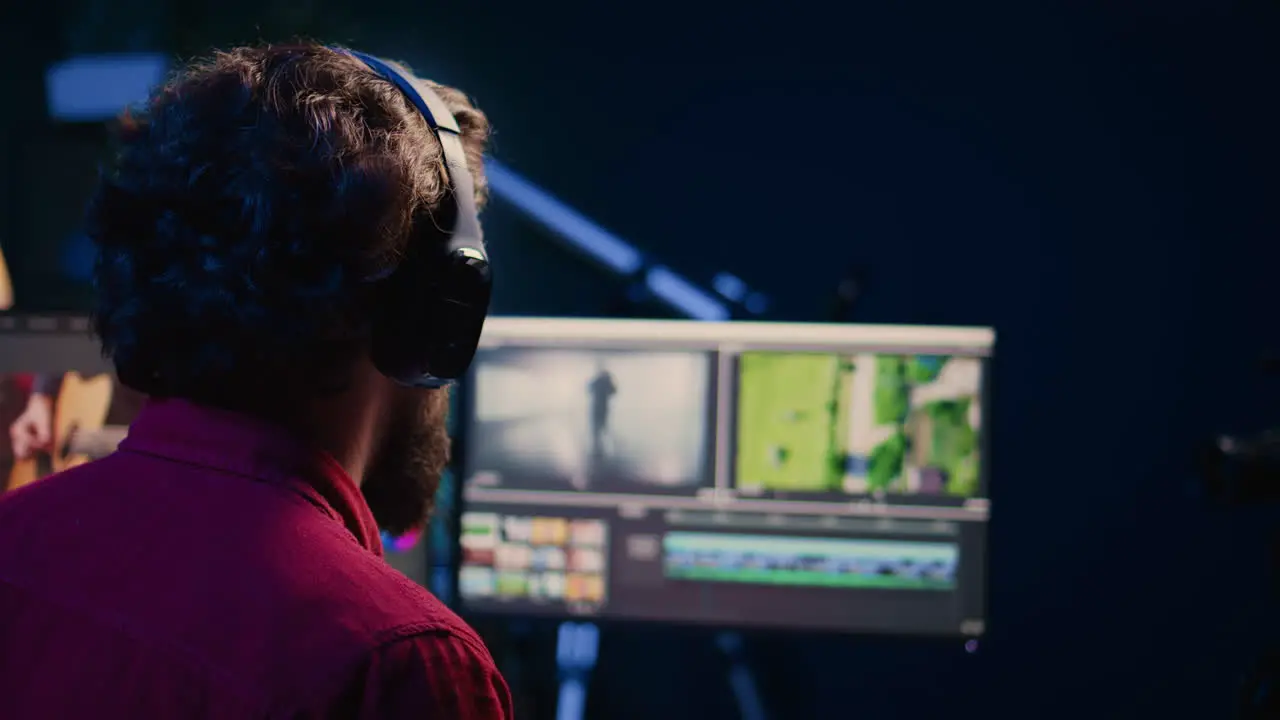 Videographer adjusting clips while listening music in headphones