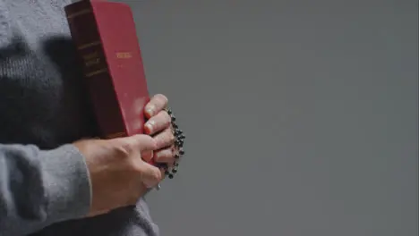 Side Profile Shot of Senior Man Holding Holy Bible with Copy Space