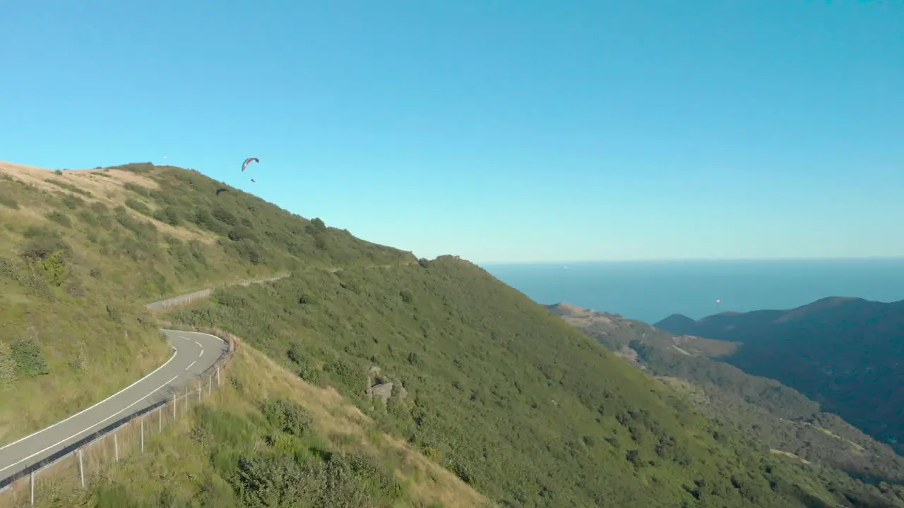 Paraglider soars left exits frame