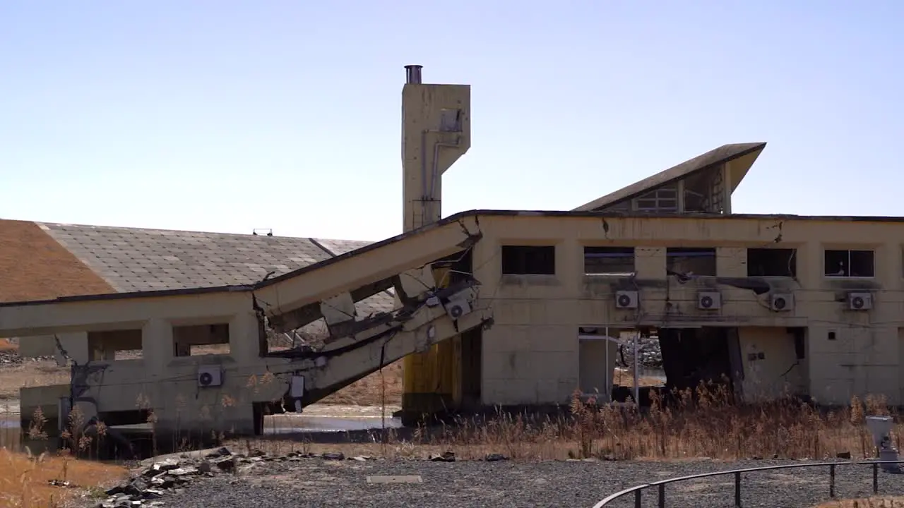 Slow motion pan over destroyed building after Tohoku Tsunami in Japan