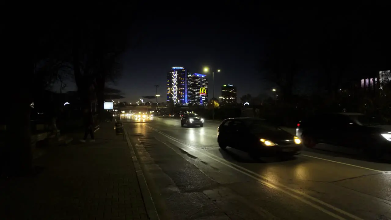 car traffic at 'Evlogi and Hristo Georgievi Boulevard' at night and people walking on the sidewalk