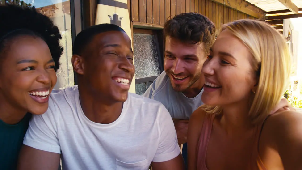 POV Shot Of Smiling Multi-Cultural Friends Outdoors At Home Posing For Selfie On Mobile Phone