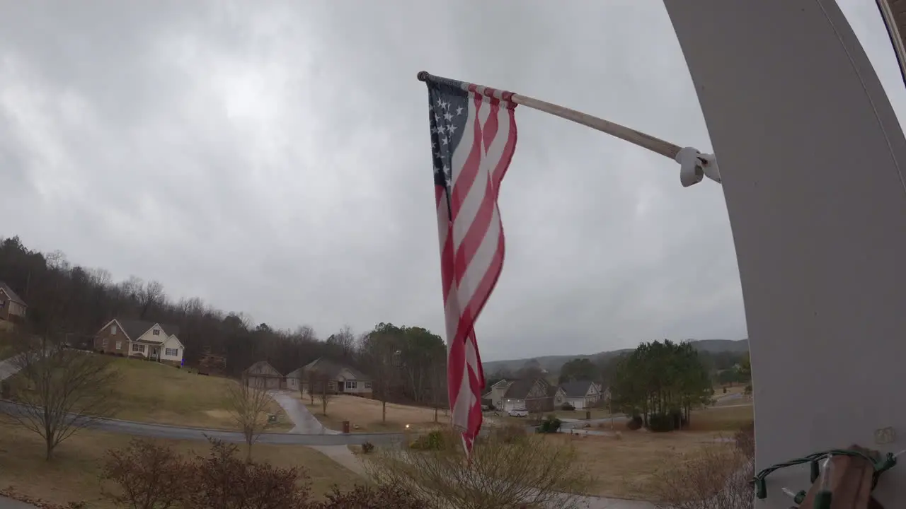 Overcast gloomy American suburbs USA flag blowing in wind timelapse