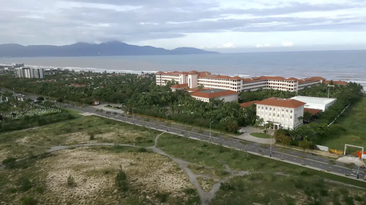 flying over mountain tops and into the city of Da Nang in Vietnam during a cloudy day