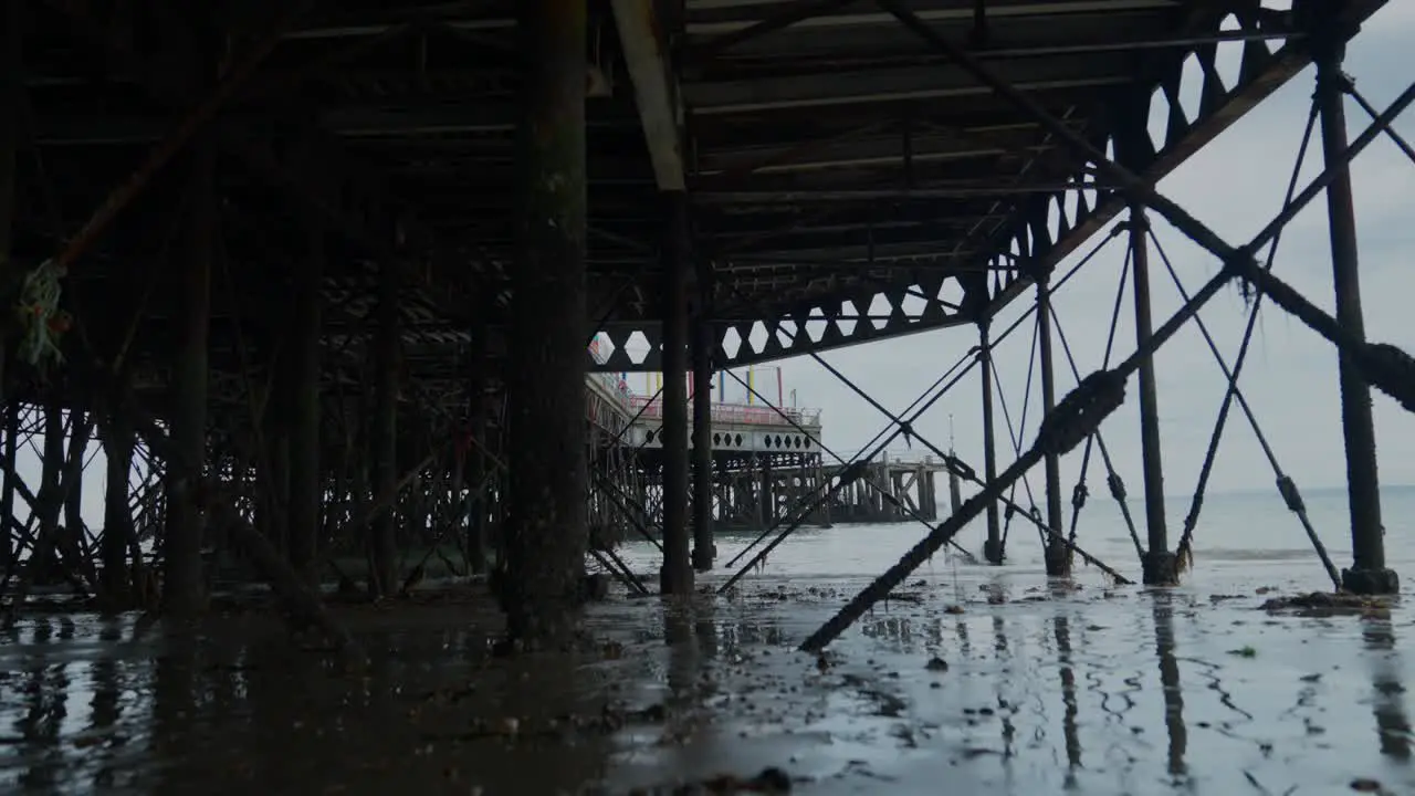 Wide shot of the structure underneath a seaside pier