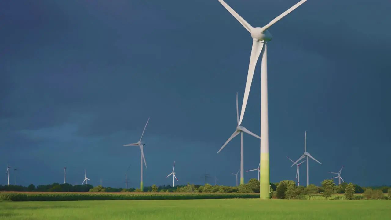 Rotating wind turbines on the background of the dark stormy sky